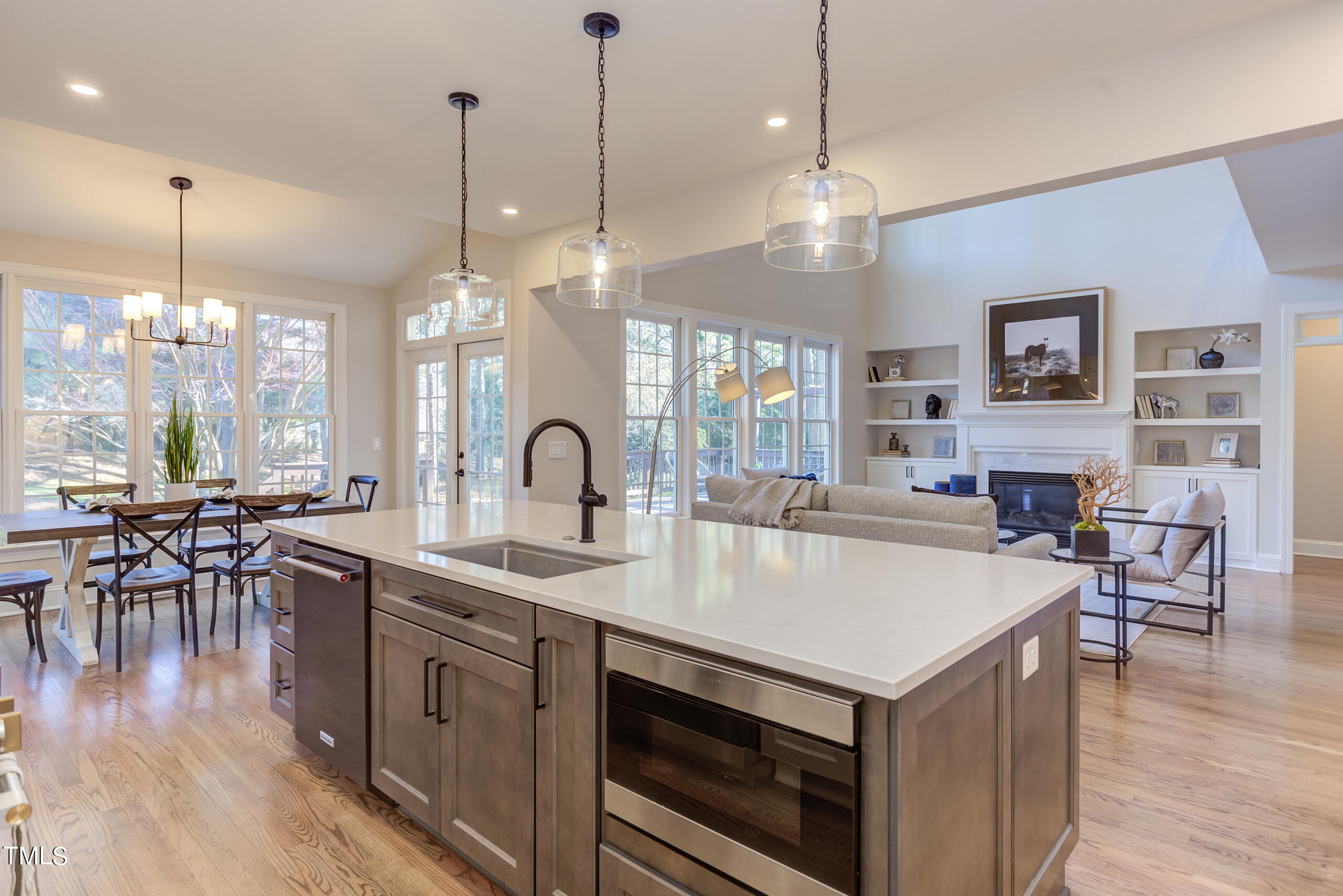 737 Loch Highlands Drive Raleigh, NC 27606 - Photo 28 of 85 a large kitchen with kitchen island a stove a sink a center island a dining table and chairs