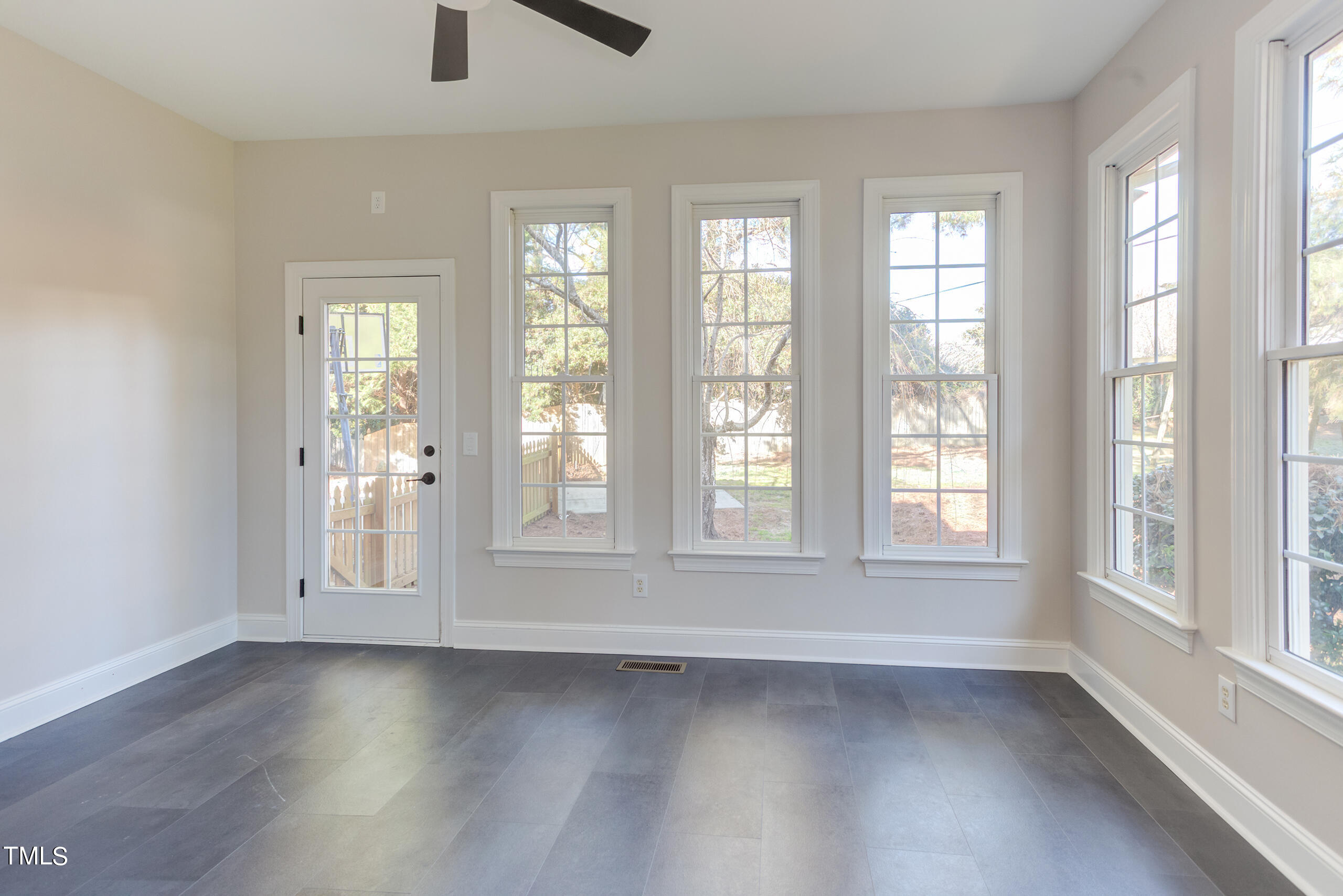 737 Loch Highlands Drive Raleigh, NC 27606 - Photo 30 of 85 an empty room with wooden floor and windows