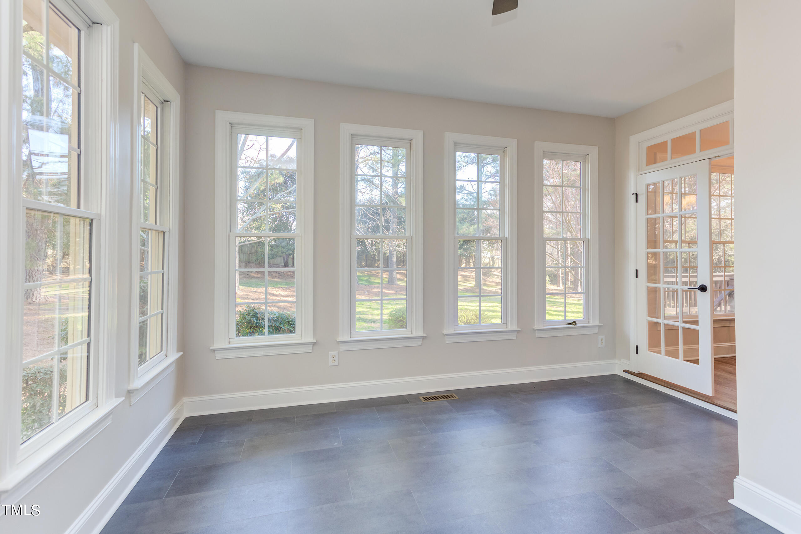 737 Loch Highlands Drive Raleigh, NC 27606 - Photo 31 of 85 a view of empty room with wooden floor and fan