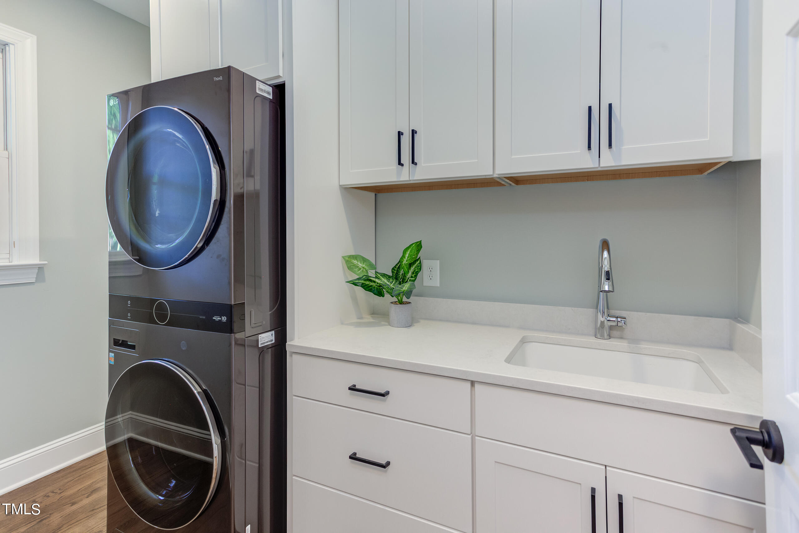 737 Loch Highlands Drive Raleigh, NC 27606 - Photo 37 of 85 a bathroom with a sink and a washer dryer