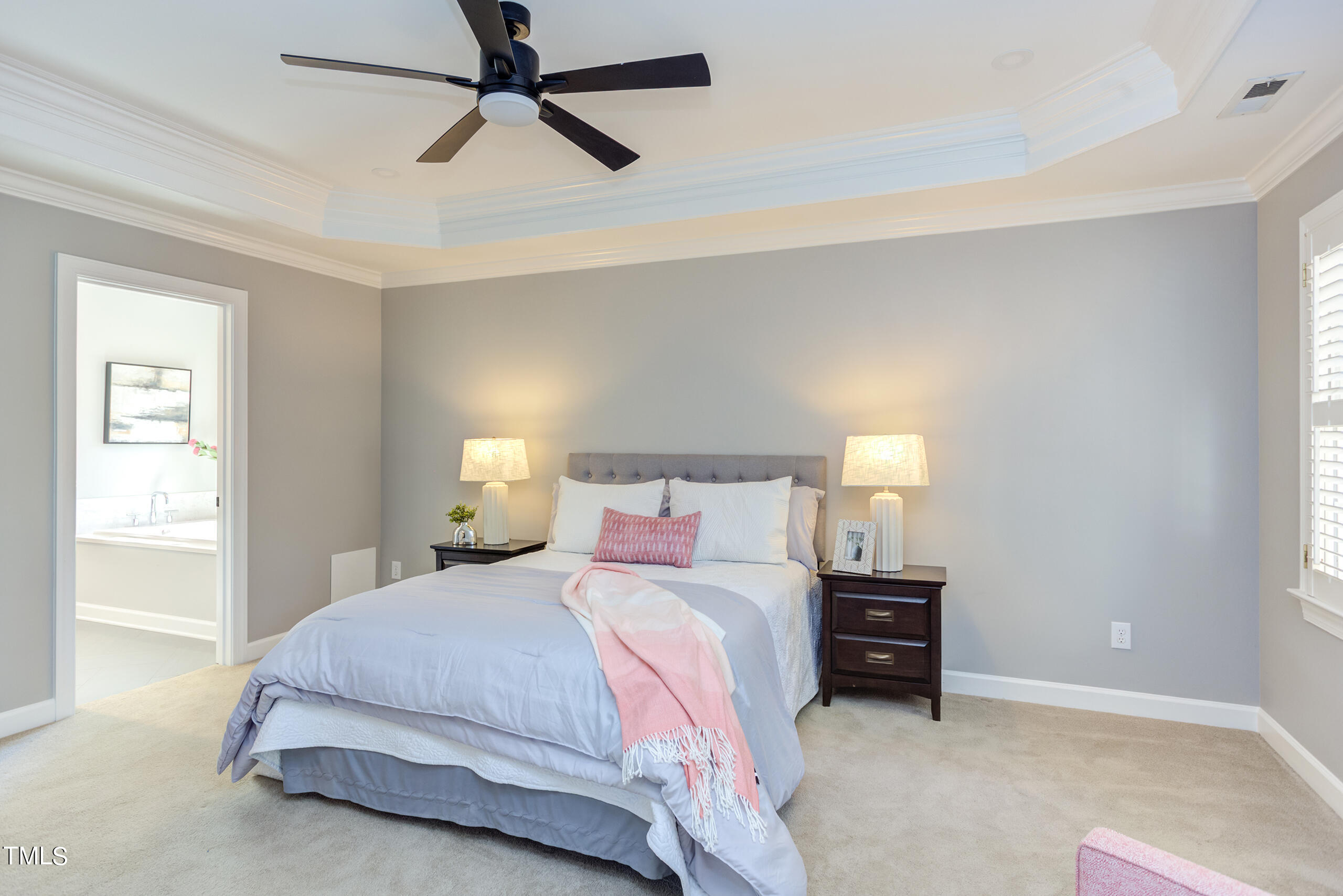 737 Loch Highlands Drive Raleigh, NC 27606 - Photo 42 of 85 a bedroom with a bed and a ceiling fan