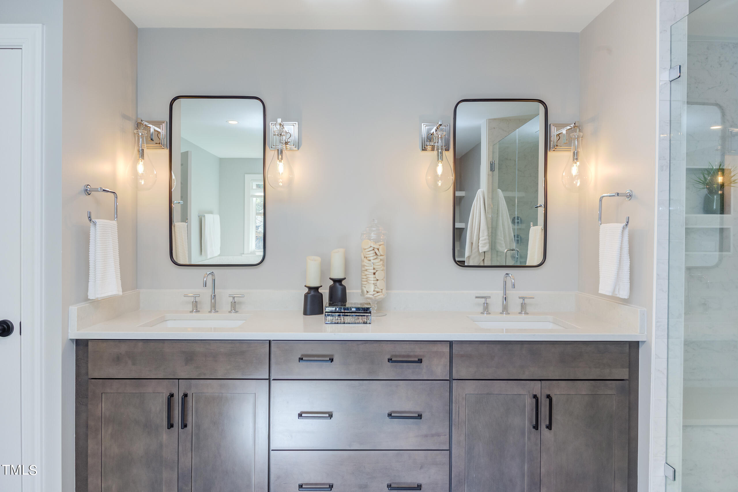 737 Loch Highlands Drive Raleigh, NC 27606 - Photo 45 of 85 a bathroom with double vanity sinks and a mirror