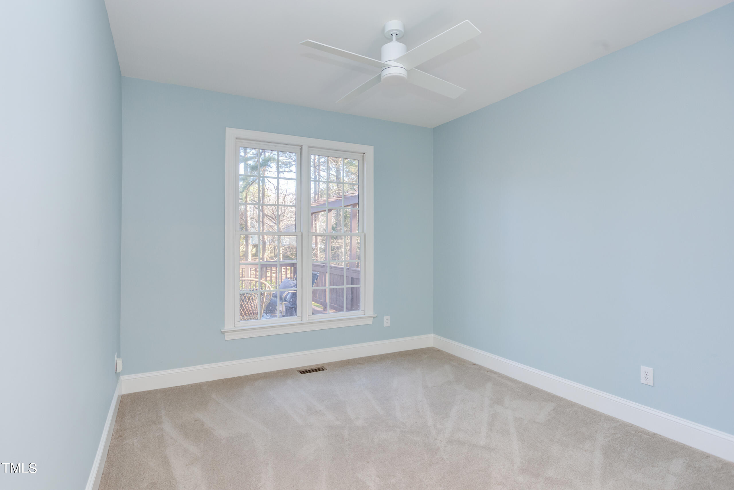 737 Loch Highlands Drive Raleigh, NC 27606 - Photo 49 of 85 an empty room with a window and a fan