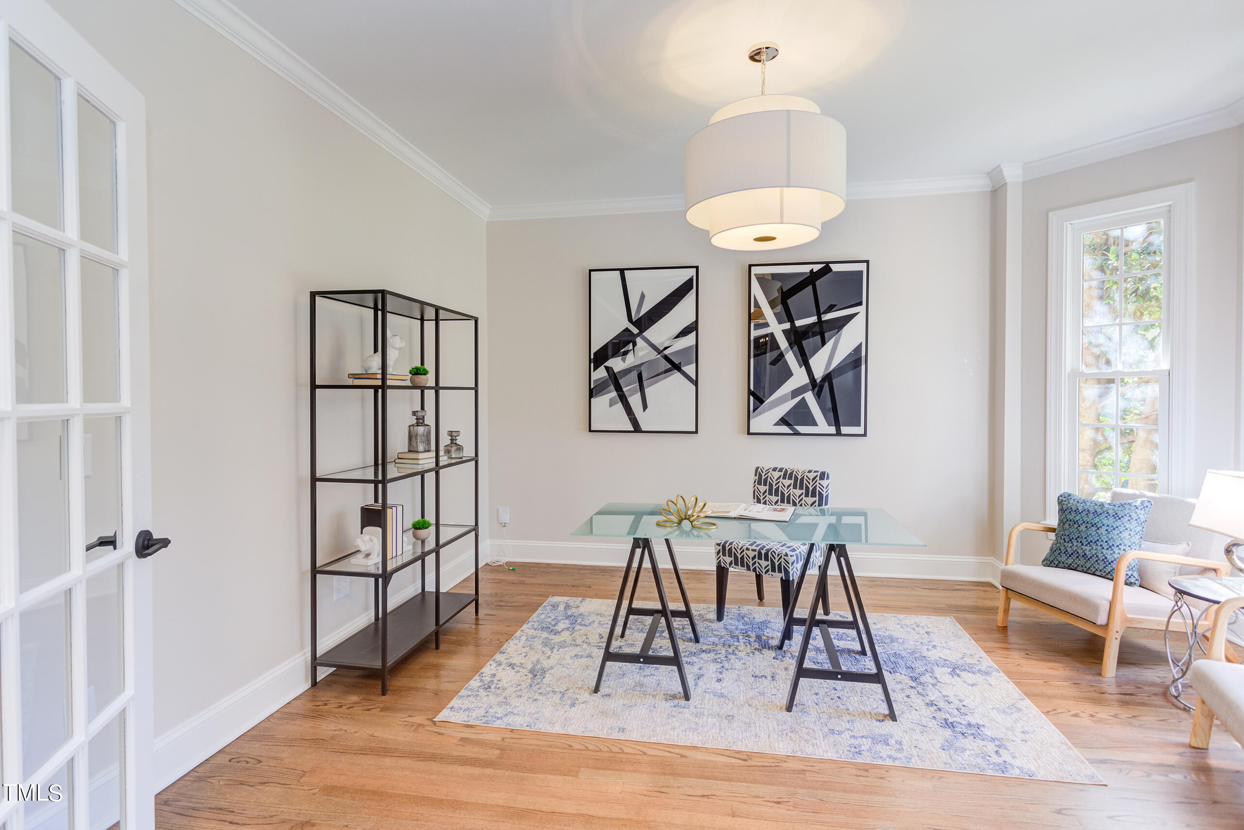 737 Loch Highlands Drive Raleigh, NC 27606 - Photo 5 of 85 a dining room with wooden floor a chandelier a wooden table and chairs