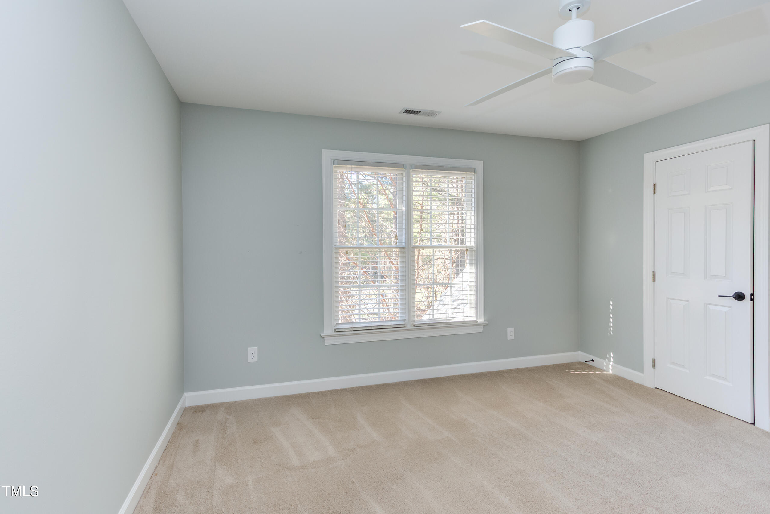 737 Loch Highlands Drive Raleigh, NC 27606 - Photo 55 of 85 an empty room with a window and a fan