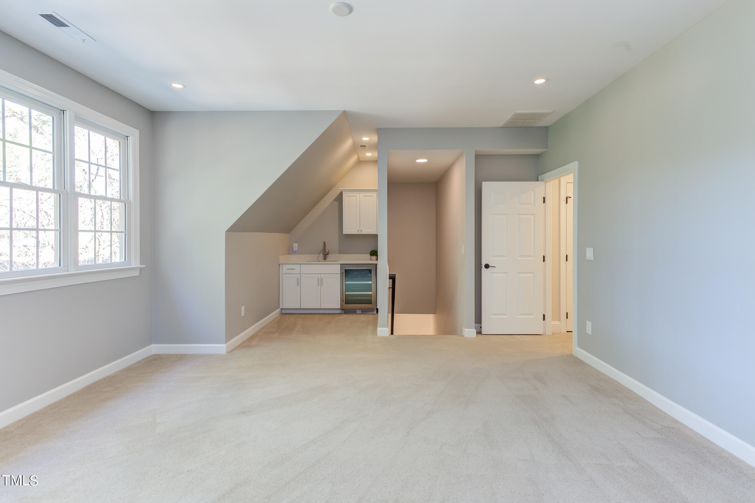737 Loch Highlands Drive Raleigh, NC 27606 - Photo 59 of 85 an empty room with windows and pillars in it