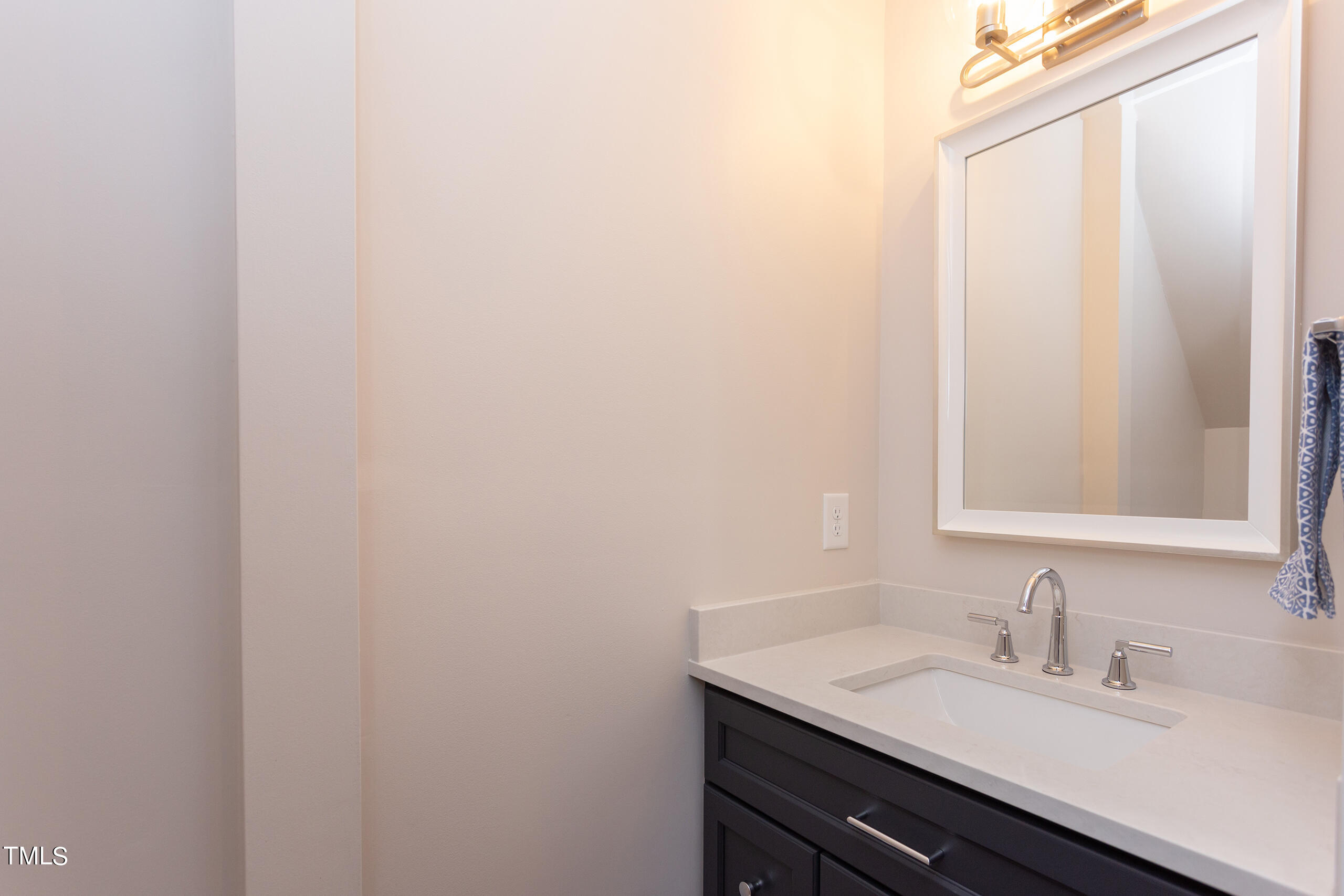 737 Loch Highlands Drive Raleigh, NC 27606 - Photo 64 of 85 a bathroom with a granite countertop sink and a mirror