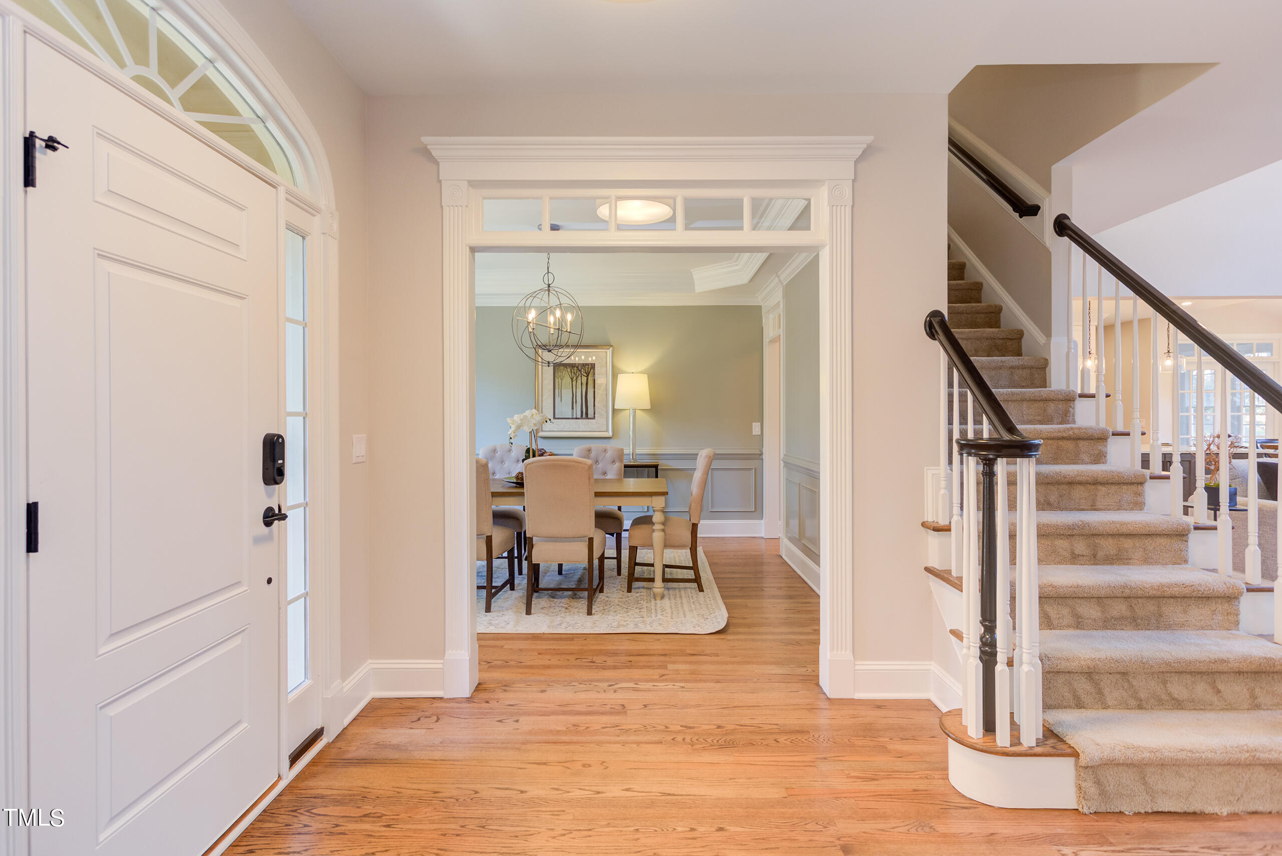 737 Loch Highlands Drive Raleigh, NC 27606 - Photo 9 of 85 a view of a hallway with wooden floor and dining room