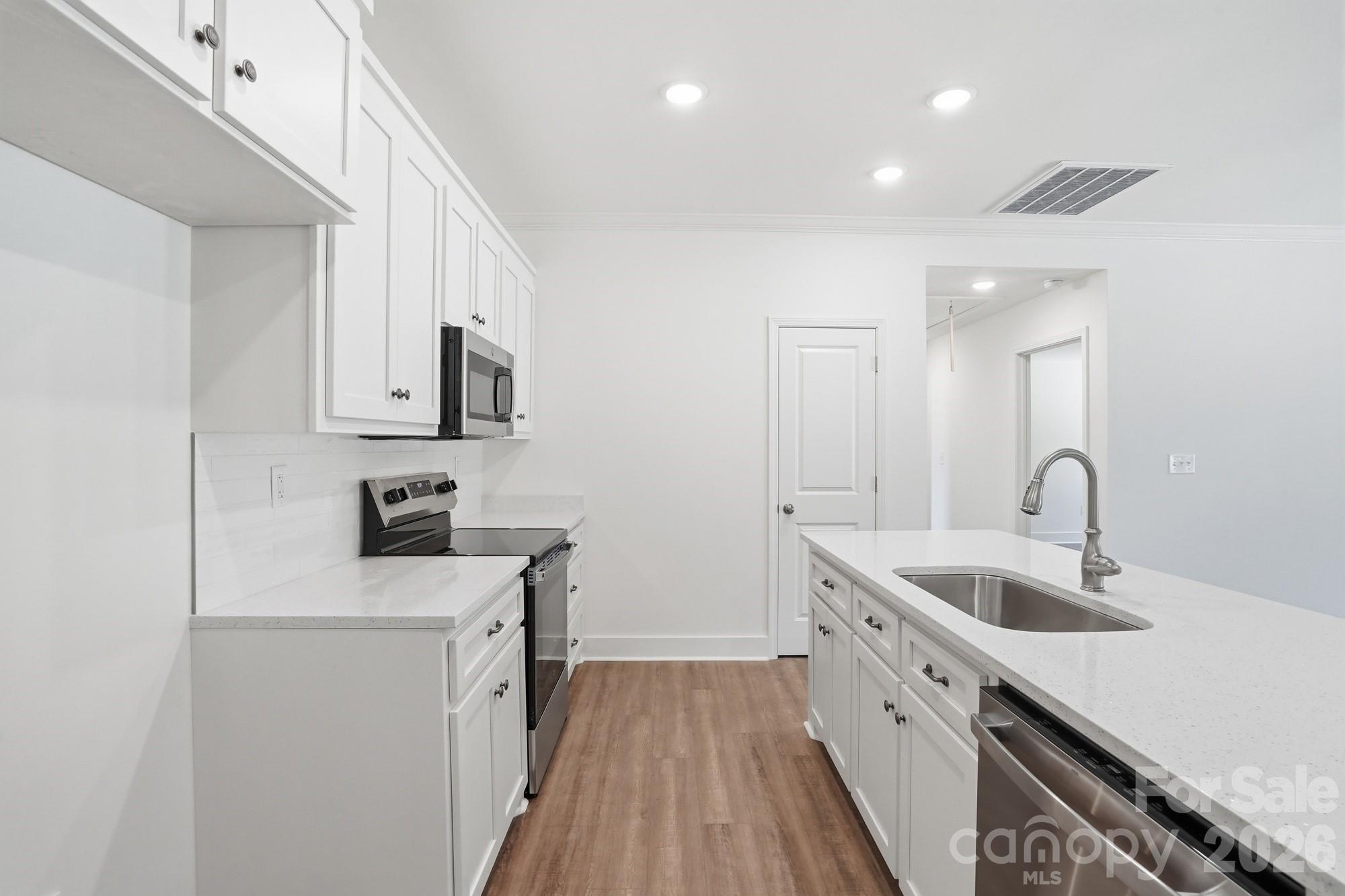339 Peachtree Road Rock Hill, SC 29730 - Photo 15 of 39 a kitchen with a sink dishwasher a stove and a refrigerator with wooden floor