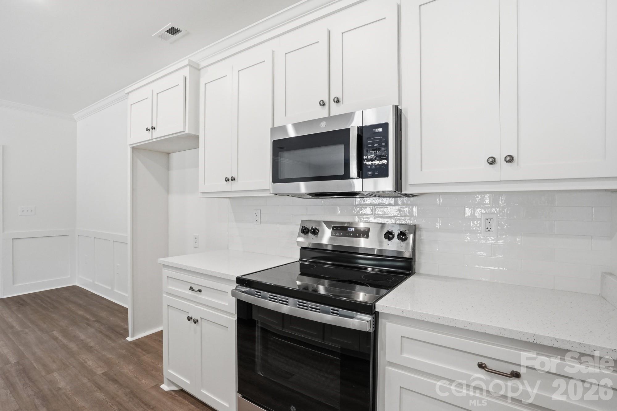 339 Peachtree Road Rock Hill, SC 29730 - Photo 17 of 39 a kitchen with stainless steel appliances granite countertop white cabinets and a stove top oven