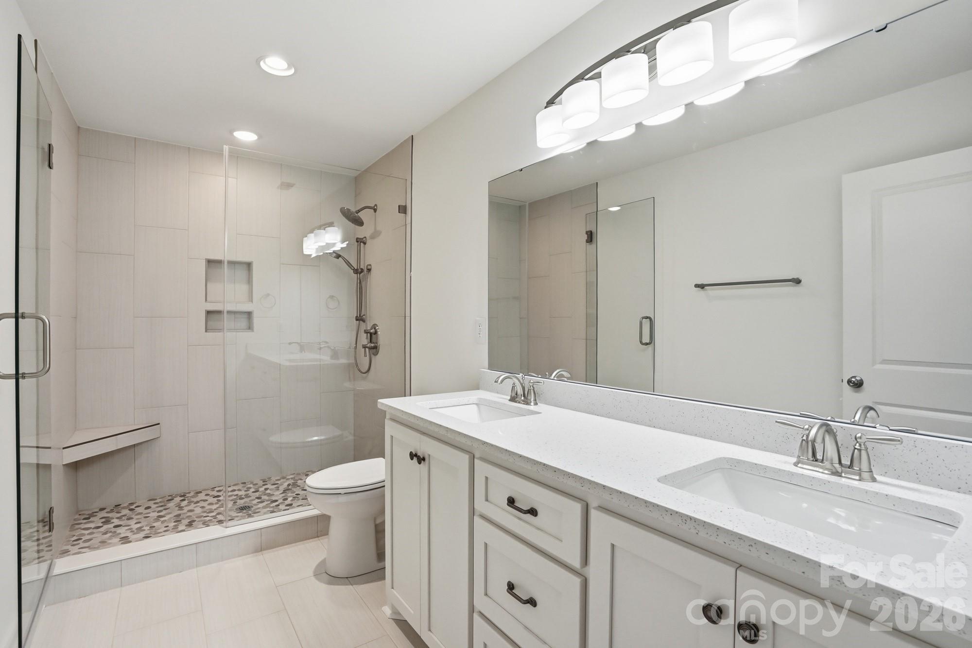 339 Peachtree Road Rock Hill, SC 29730 - Photo 22 of 39 a spacious bathroom with a granite countertop sink a toilet and a mirror