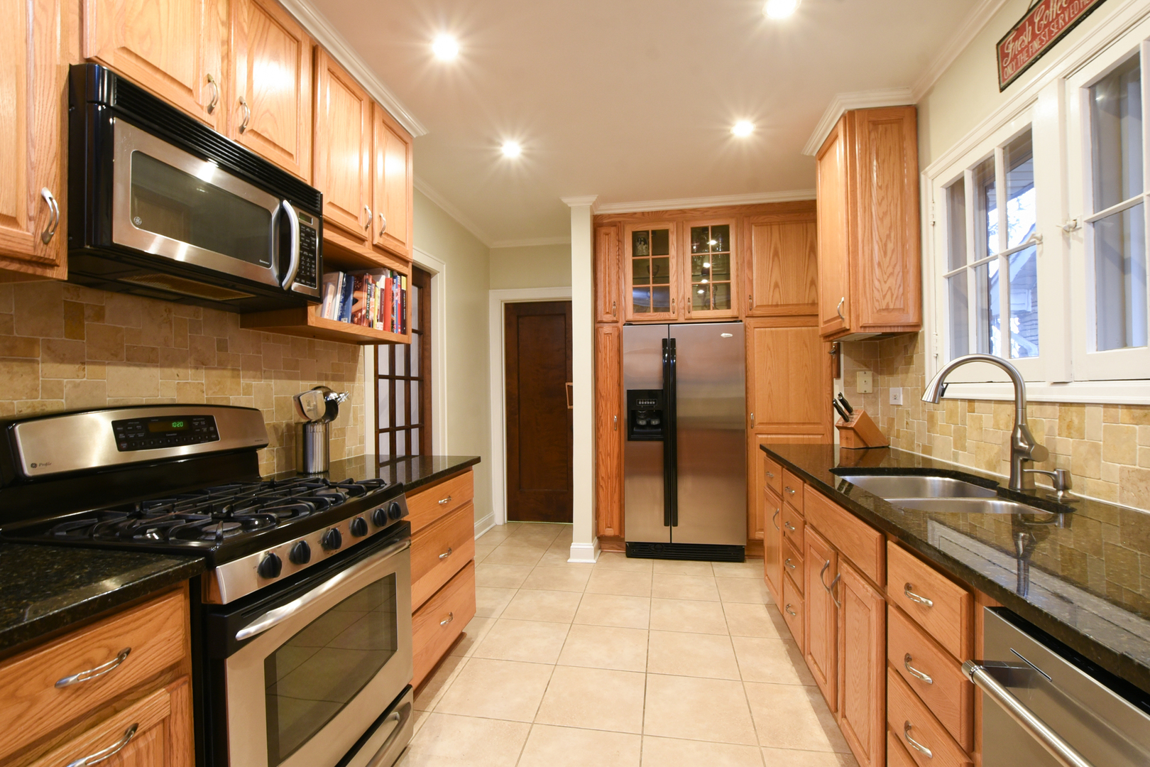 328 Olmsted Road Riverside, IL 60546 - Photo 18 of 45 a kitchen with stainless steel appliances granite countertop a sink stove and refrigerator