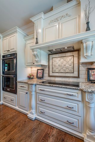 a kitchen with stainless steel appliances granite countertop a stove and cabinets