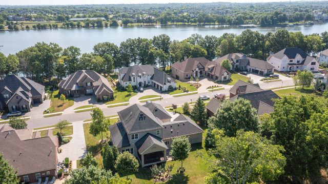 an aerial view of a house with outdoor space and lake view