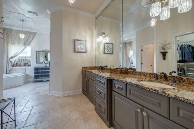a spacious bathroom with a granite countertop sink a mirror and a shower