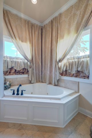 a bathroom with bathtub and window