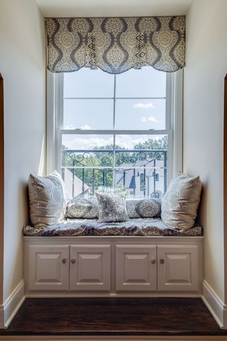 a living room with furniture and a floor to ceiling window