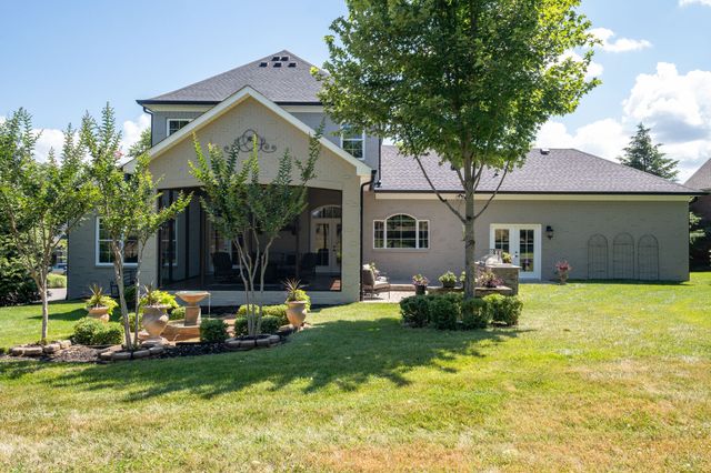 a view of a patio with couches and a table and chairs with wooden floor and fence