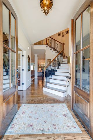 a view of entryway and hall with wooden floor