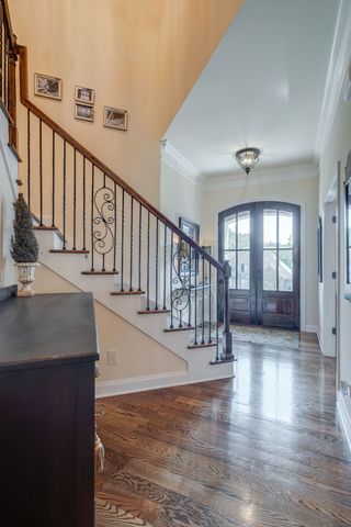 a view of entryway and hall with wooden floor