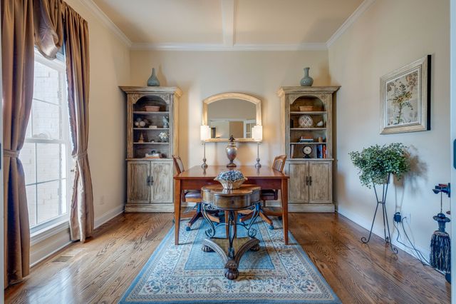 a view of a workspace with furniture and a potted plant