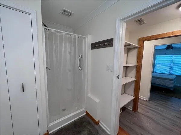 a view of walk in closet with clothes and shoes