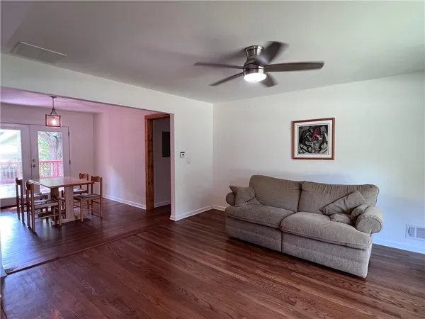 a living room with furniture and wooden floor