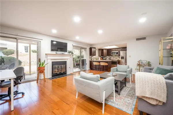 a living room with fireplace furniture and a fireplace