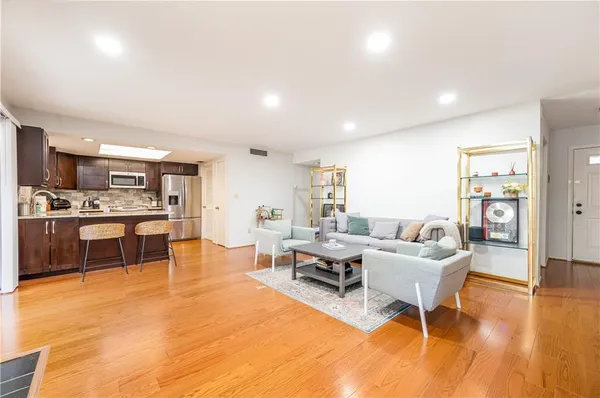 a living room with furniture and kitchen view