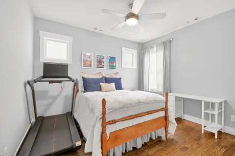 a bedroom with bed and wooden floor