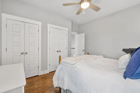 a spacious bedroom with a bed and a chandelier