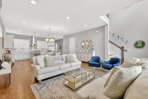 a living room with furniture and kitchen view