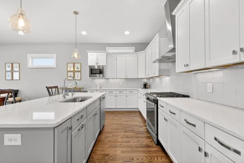 a kitchen with granite countertop a sink and cabinets
