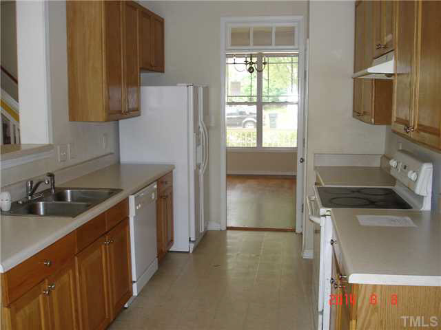 3418 Sunbright Lane Raleigh, NC 27610 - Photo 3 of 11 a kitchen with a sink a stove and a refrigerator