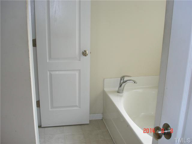 3418 Sunbright Lane Raleigh, NC 27610 - Photo 7 of 11 a bathroom with a tub and shower