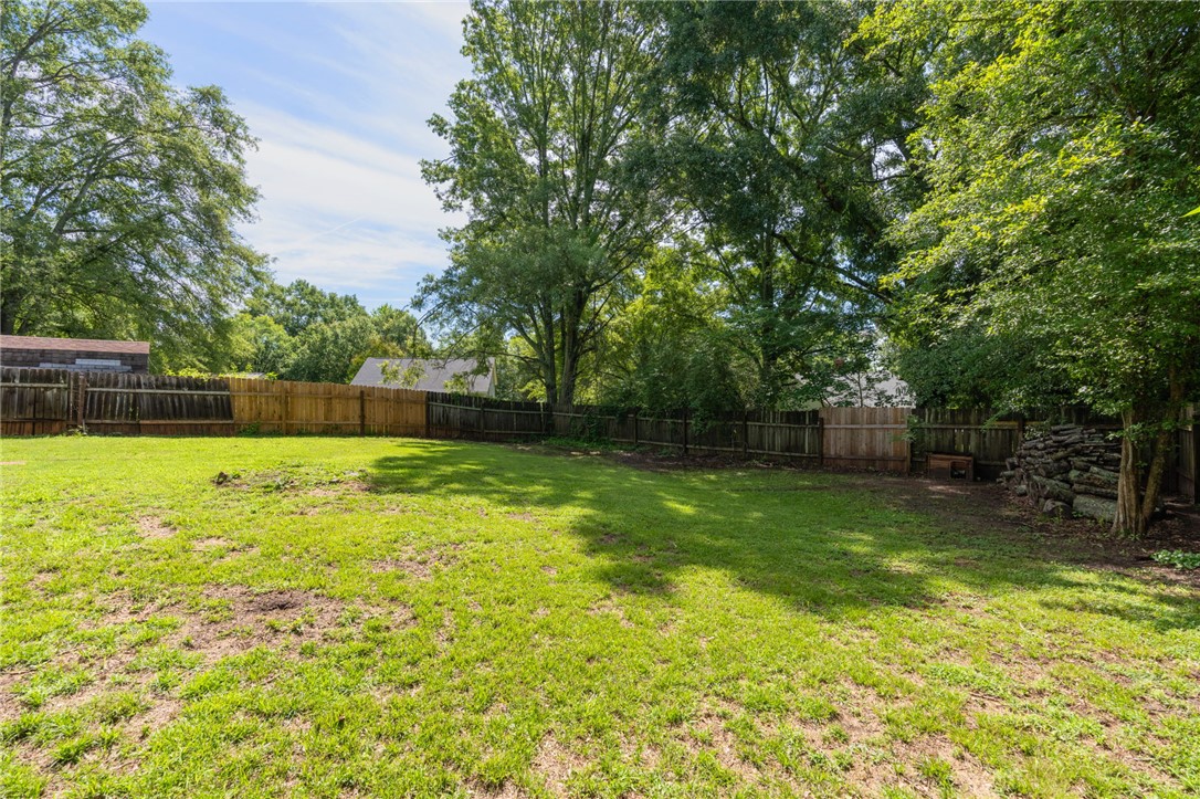 108 Tarrant Street Central, SC 29630 - Photo 33 of 42 A spacious backyard enclosed by a sturdy privacy fence, featuring mature trees and ample green space.