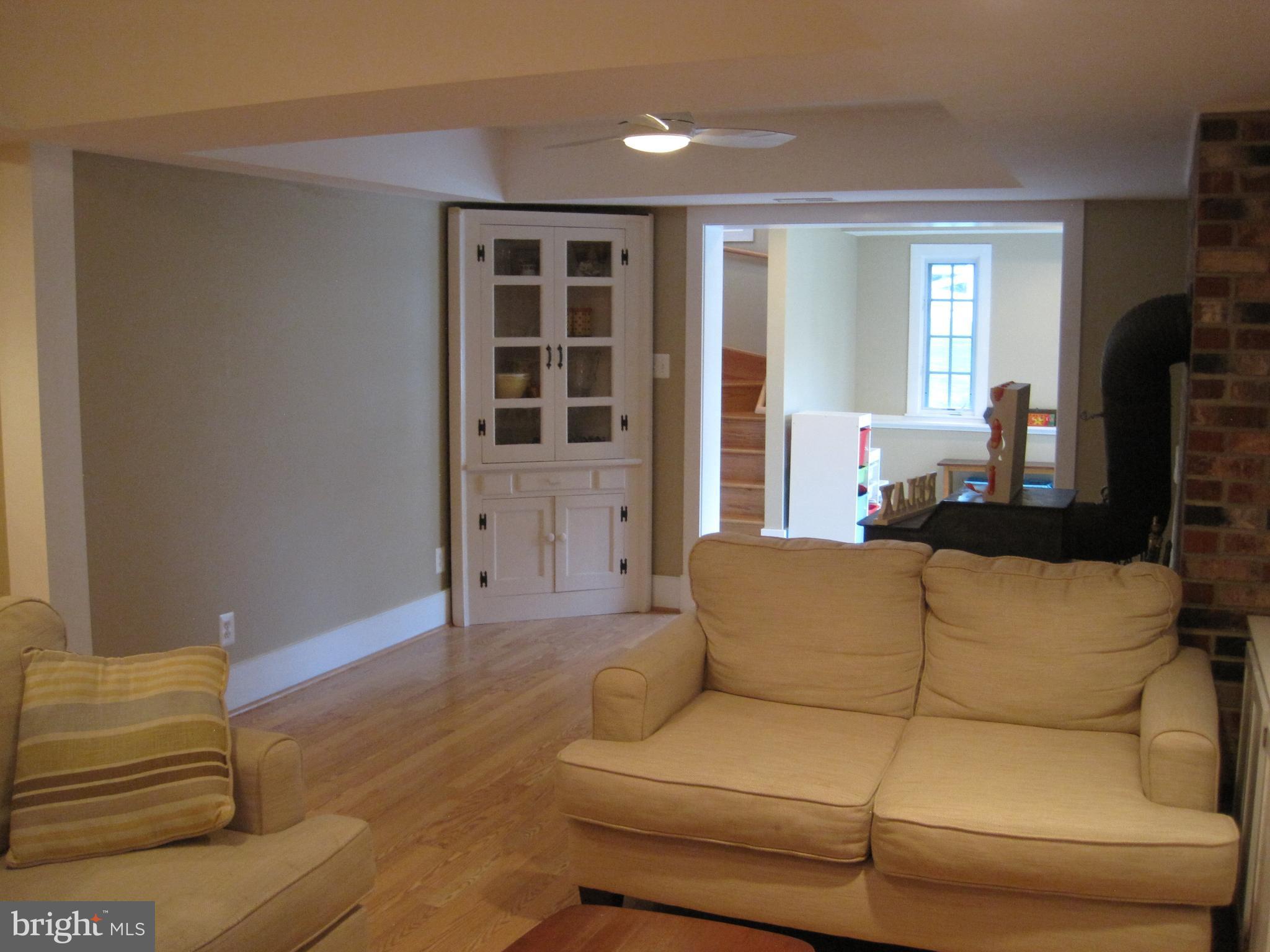 222 Stringtown Road Berryville, VA 22611 - Photo 22 of 29 a living room with furniture and a flat screen tv