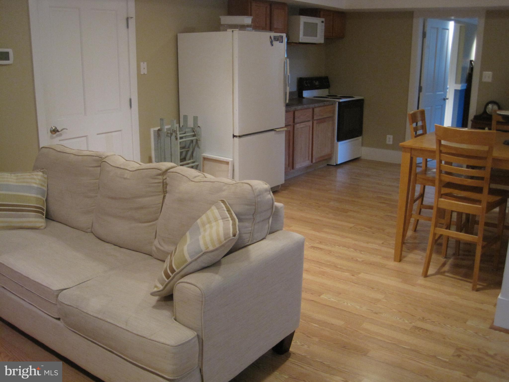 222 Stringtown Road Berryville, VA 22611 - Photo 23 of 29 a living room with furniture and a refrigerator
