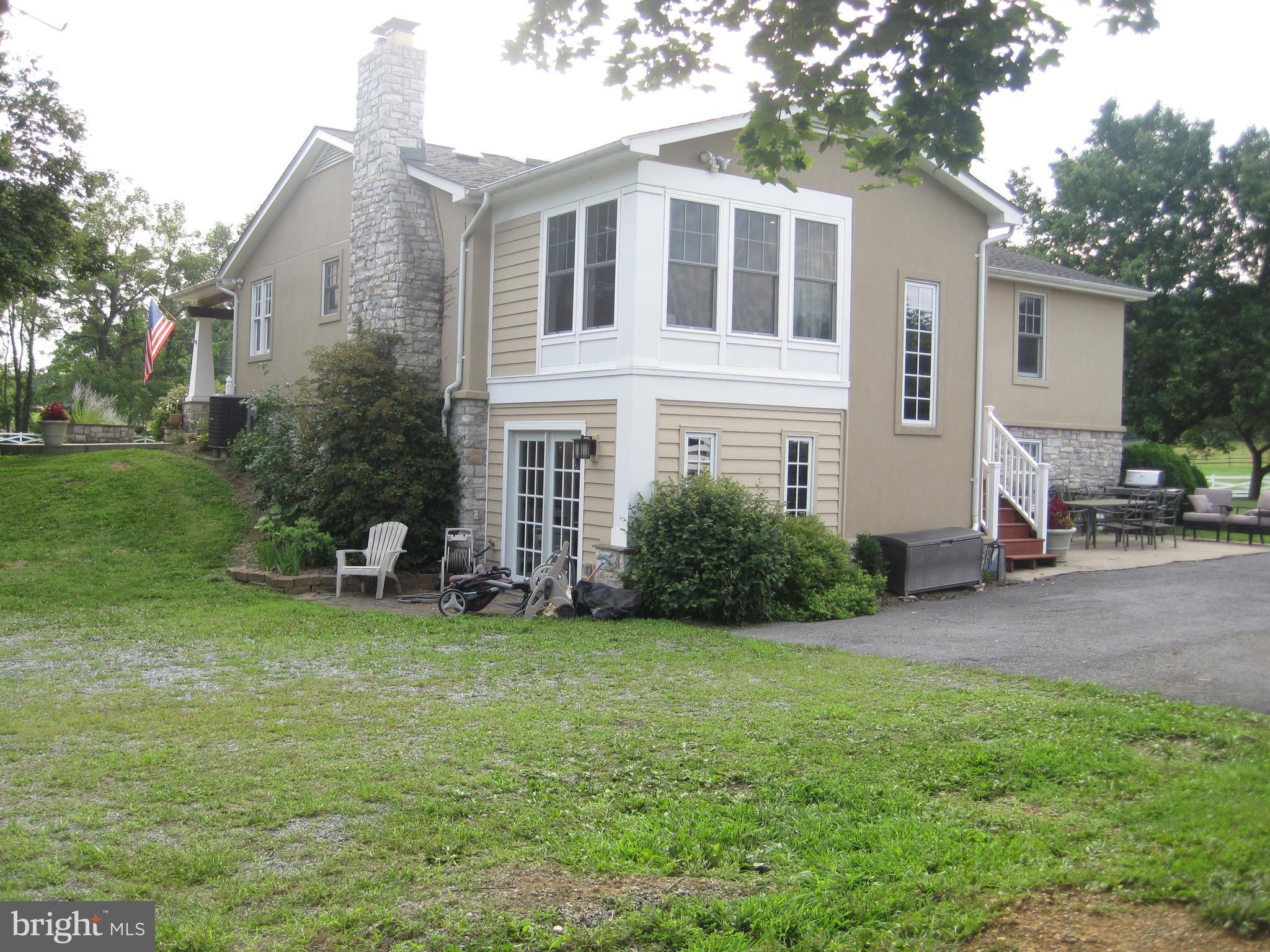 222 Stringtown Road Berryville, VA 22611 - Photo 5 of 29 a front view of a house with a yard and trees
