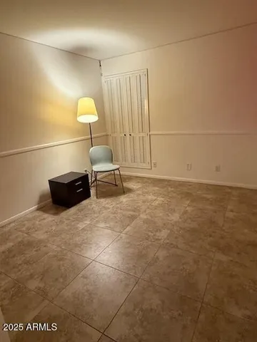 a view of a closet area with ceiling fan