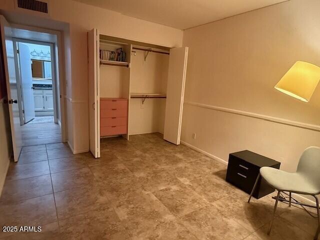 1246 East Palacio Lane Phoenix, AZ 85014 - Photo 14 of 17 a view of a closet area with ceiling fan