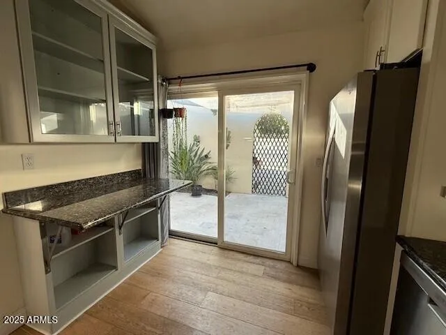 a kitchen with stainless steel appliances granite countertop a refrigerator and a sink