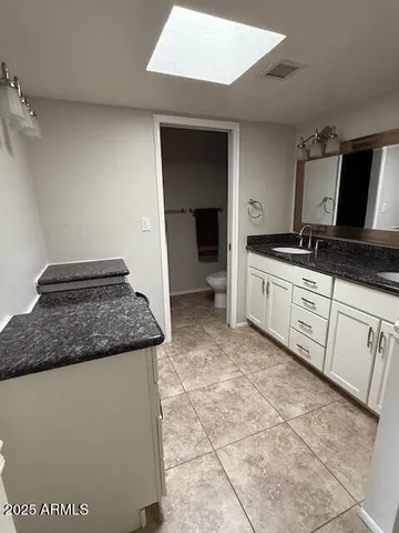 a kitchen with granite countertop a sink and a stove