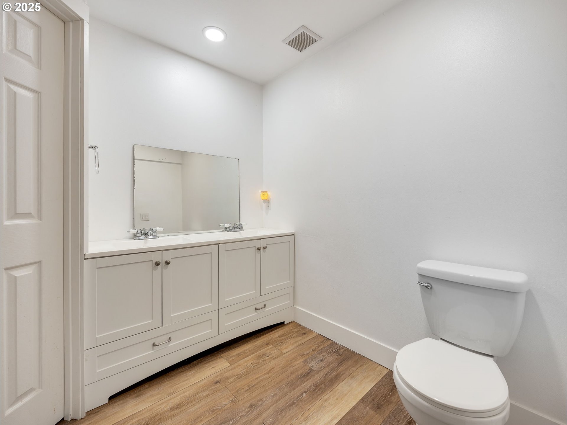 64711 East Sandy River Lane Rhododendron, OR 97049 - Photo 23 of 47 a bathroom with a toilet a sink a vanity and mirror