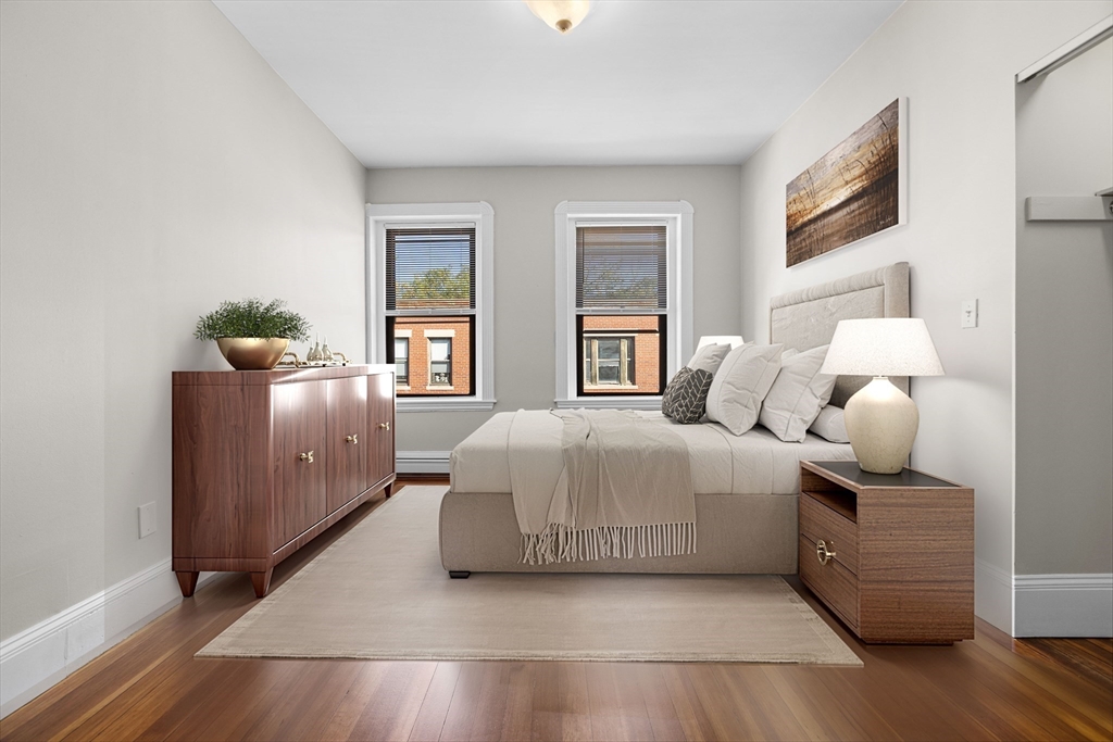 32-34 Ditson Street, Unit 6 Boston, MA 02122 - Photo 14 of 27 a bedroom with a bed and wooden floor