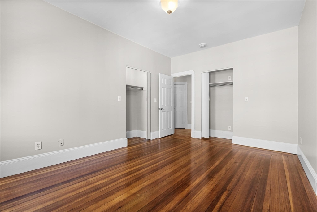 32-34 Ditson Street, Unit 6 Boston, MA 02122 - Photo 16 of 27 a view of an empty room with wooden floor