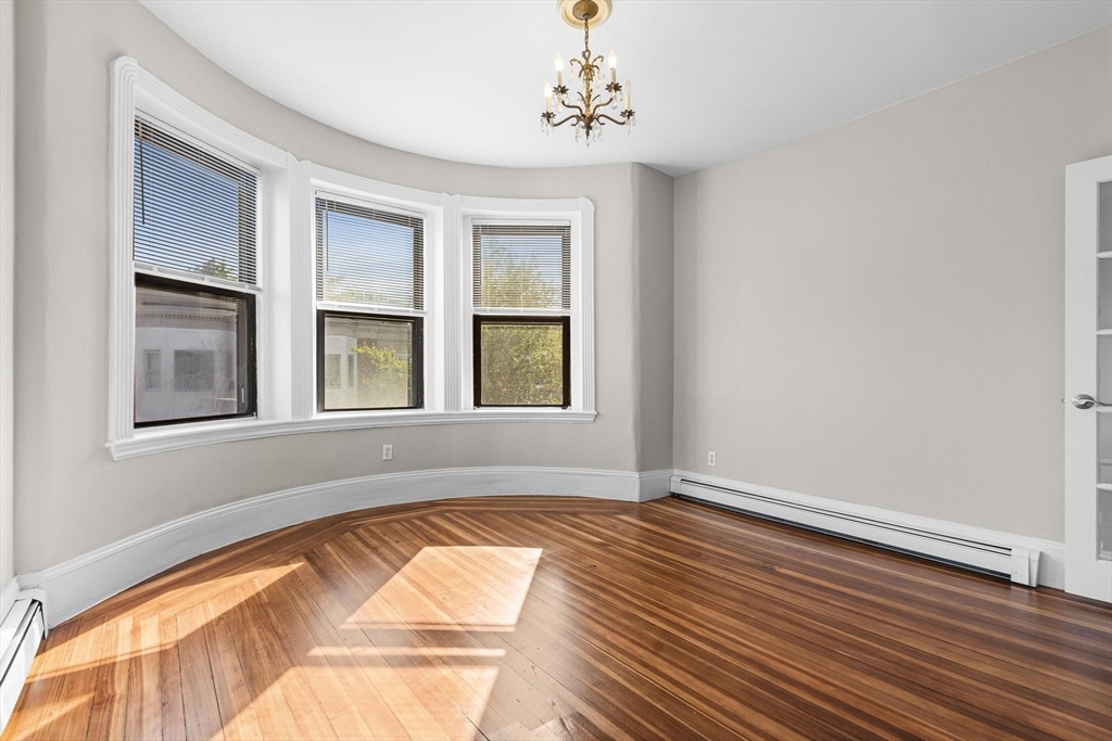 32-34 Ditson Street, Unit 6 Boston, MA 02122 - Photo 3 of 27 a view of empty room with wooden floor and fan