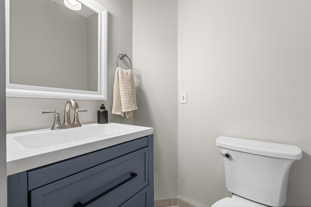32-34 Ditson Street, Unit 6 Boston, MA 02122 - Photo 7 of 27 a bathroom with a sink a toilet and a mirror