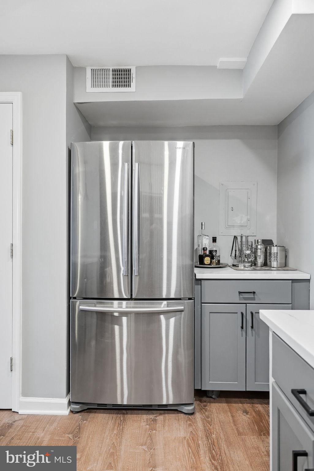 1712 Corcoran Street Northwest, Unit 2 Washington, DC 20009 - Photo 12 of 24 a kitchen with kitchen island granite countertop a refrigerator and a sink