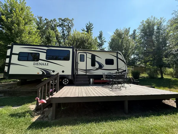 a view of house with swimming pool and outdoor seating